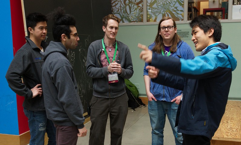 Tech team members Ian Kelling and Andrew Engelbrecht chat with friends at the LibrePlanet 2019 conference.